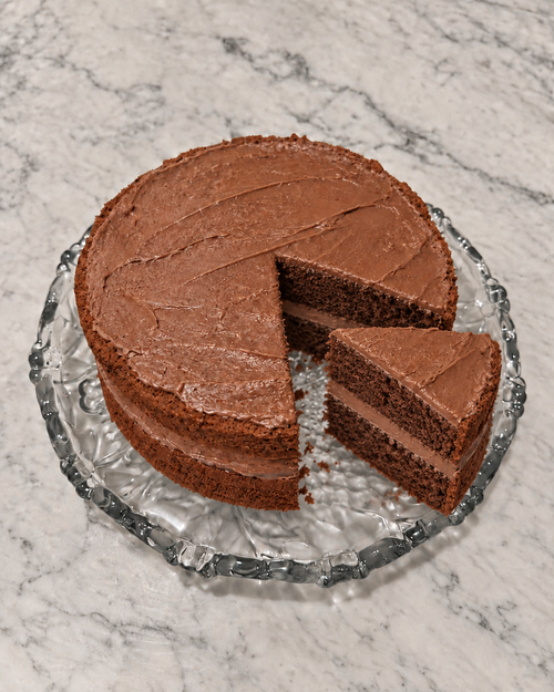 Two-layer Cadbury Delight Cake with one slice removed